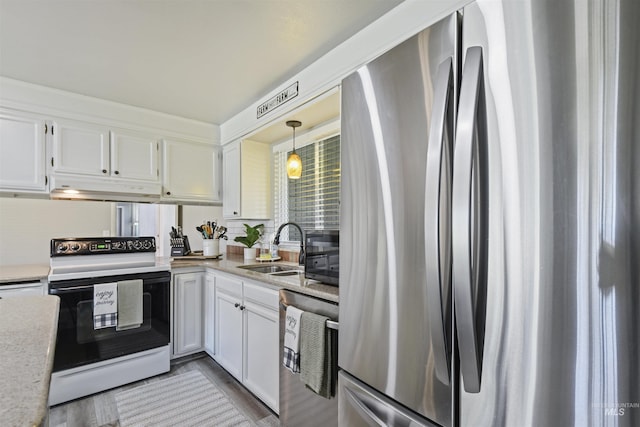 11457 S Cloverdale, Kuna, ID 83634 - kitchen with a sink, white cabinets, under cabinet range hood, and stainless steel appliances
