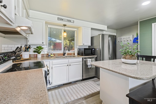 11457 S Cloverdale, Kuna, ID 83634 - kitchen with black microwave, white cabinets, range with electric cooktop, stainless steel dishwasher, and a sink