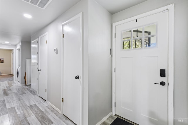 11457 S Cloverdale, Kuna, ID 83634 - foyer entrance with light wood finished floors, baseboards, visible vents, and washer / dryer