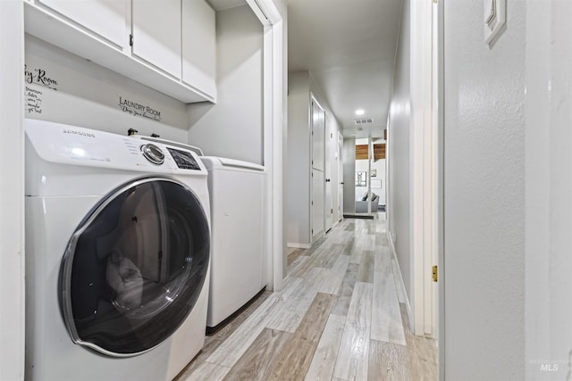 11457 S Cloverdale, Kuna, ID 83634 - clothes washing area with light wood-style flooring, visible vents, and cabinet space