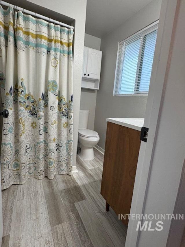 11457 S Cloverdale, Kuna, ID 83634 - full bath with a shower with shower curtain, vanity, toilet, and wood finished floors