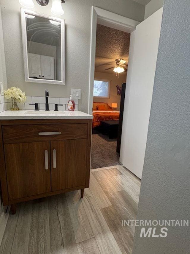 11457 S Cloverdale, Kuna, ID 83634 - ensuite bathroom with a textured wall, ensuite bathroom, vanity, and wood finished floors