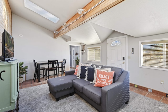 11457 S Cloverdale, Kuna, ID 83634 - living room featuring vaulted ceiling with skylight, baseboards, and tile patterned floors