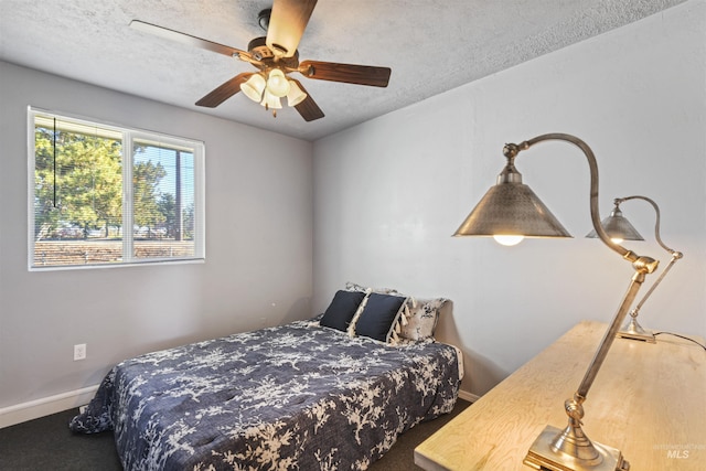 11457 S Cloverdale, Kuna, ID 83634 - bedroom featuring ceiling fan, a textured ceiling, baseboards, and carpet floors