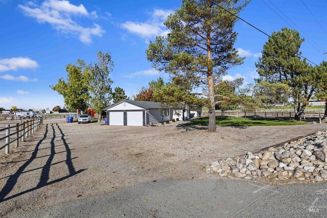11457 S Cloverdale, Kuna, ID 83634 - exterior space featuring an outbuilding, fence, an attached garage, and dirt driveway