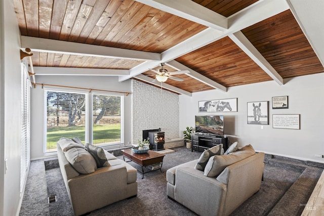 11457 S Cloverdale, Kuna, ID 83634 - carpeted living room featuring a wood stove, vaulted ceiling with beams, baseboards, and wood ceiling