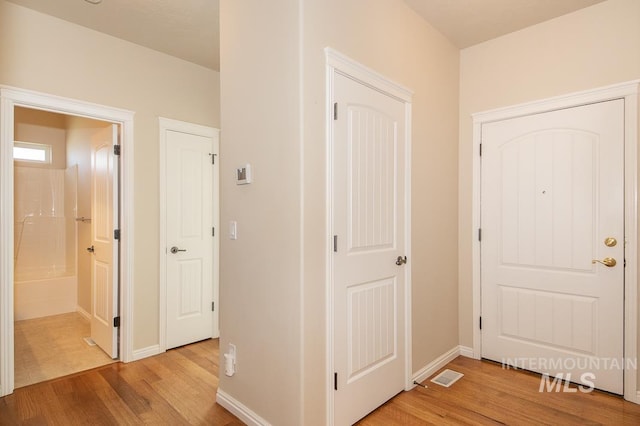 325 S Whisperwood Way, Boise, ID 83709 - hall featuring visible vents, light wood finished floors, and baseboards