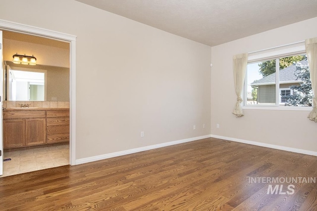 325 S Whisperwood Way, Boise, ID 83709 - spare room with dark wood-style flooring and baseboards