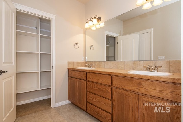 325 S Whisperwood Way, Boise, ID 83709 - full bathroom featuring double vanity, baseboards, a spacious closet, and a sink