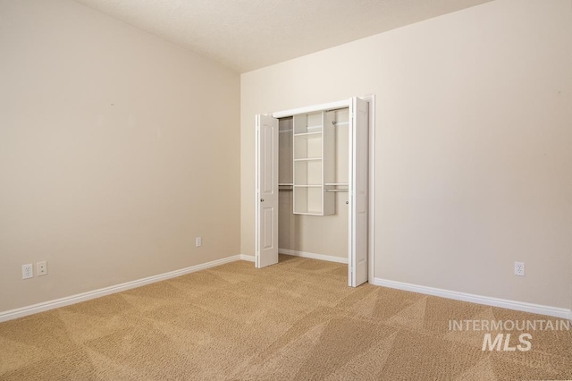 325 S Whisperwood Way, Boise, ID 83709 - unfurnished bedroom with baseboards, a closet, and light colored carpet