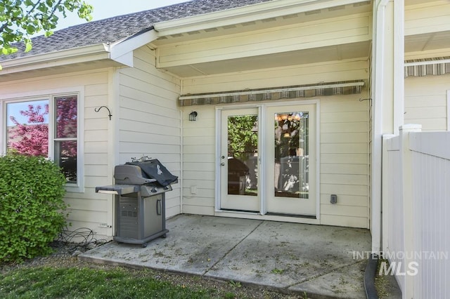 325 S Whisperwood Way, Boise, ID 83709 - view of exterior entry featuring a shingled roof and a patio area