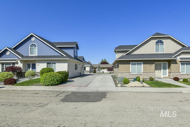 325 S Whisperwood Way, Boise, ID 83709 - view of front facade with concrete driveway and stone siding