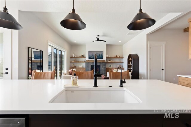 kitchen featuring pendant lighting, ceiling fan, and sink