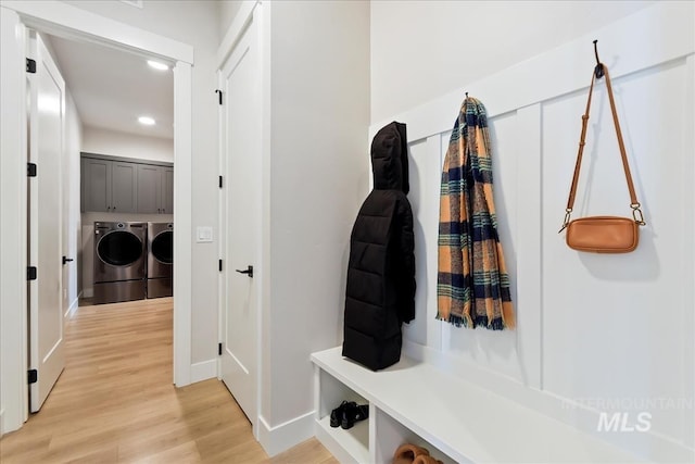 mudroom featuring washer and clothes dryer and light wood-type flooring