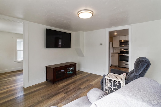 living area featuring dark wood finished floors and baseboards