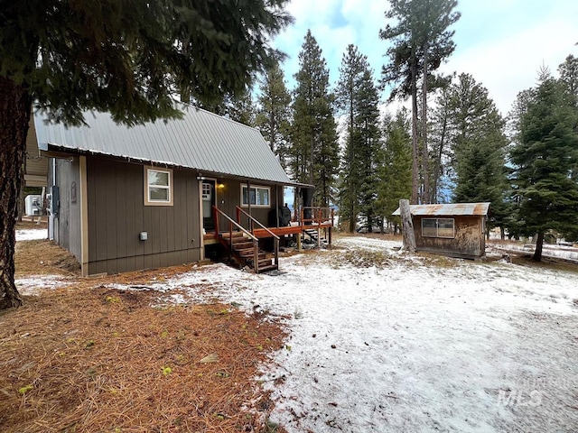 view of snow covered back of property