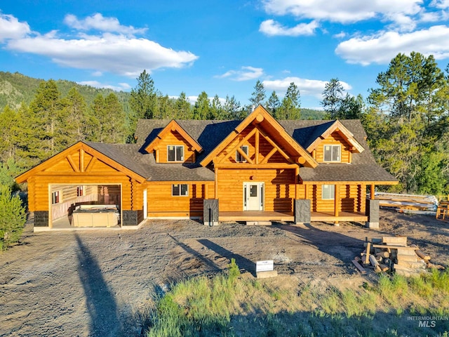 log home featuring a hot tub