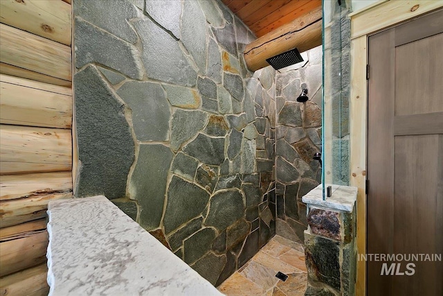 bathroom featuring wood walls, wooden ceiling, and walk in shower