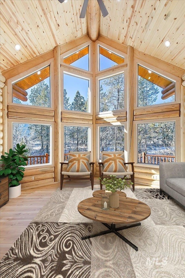 sunroom / solarium featuring vaulted ceiling, ceiling fan, and wooden ceiling