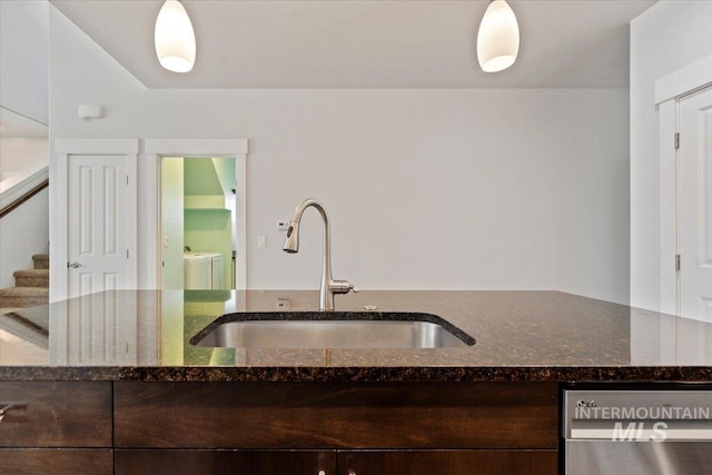 924 E Wright St, Boise, ID 83706 - kitchen with separate washer and dryer, dishwasher, dark stone countertops, and dark brown cabinetry