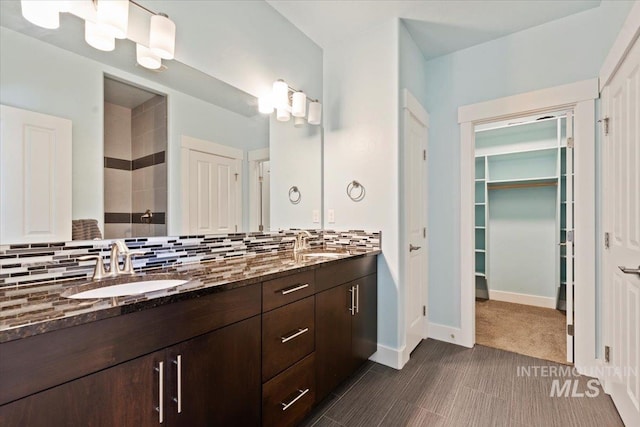 924 E Wright St, Boise, ID 83706 - full bath with double vanity, decorative backsplash, a walk in closet, and tiled shower