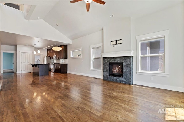 924 E Wright St, Boise, ID 83706 - unfurnished living room with a ceiling fan, high vaulted ceiling, dark wood-type flooring, and a fireplace