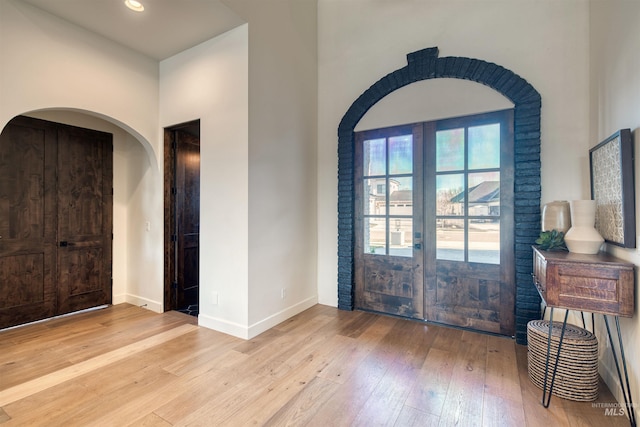 foyer entrance featuring french doors and light wood-type flooring