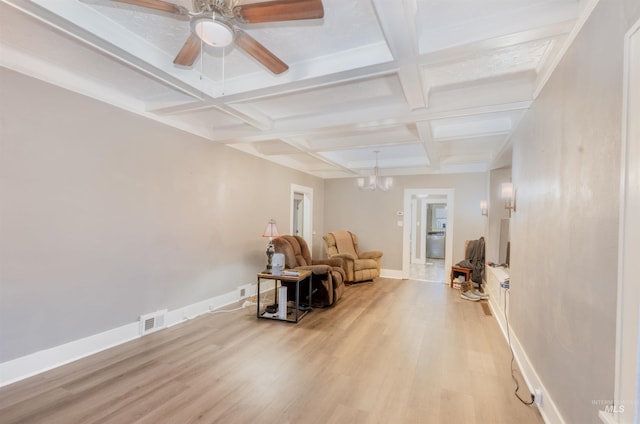 sitting room with coffered ceiling, visible vents, baseboards, beam ceiling, and light wood finished floors