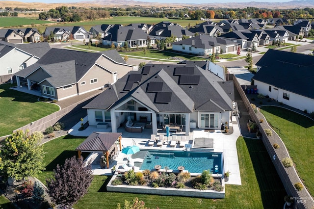 exterior space featuring outdoor lounge area, solar panels, a fenced in pool, a gazebo, and a patio