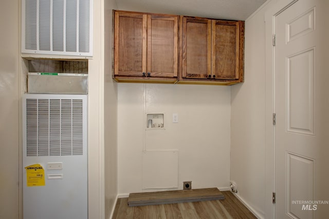 laundry area featuring cabinets, hookup for an electric dryer, washer hookup, and light hardwood / wood-style floors