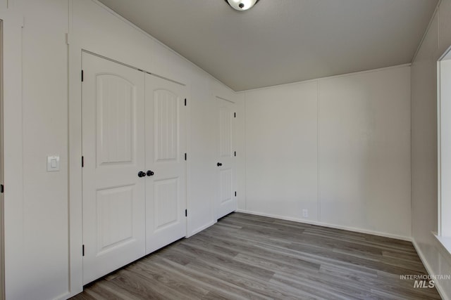 unfurnished bedroom featuring a closet and light hardwood / wood-style flooring