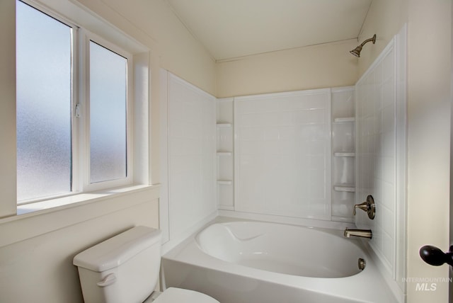 bathroom featuring toilet and washtub / shower combination