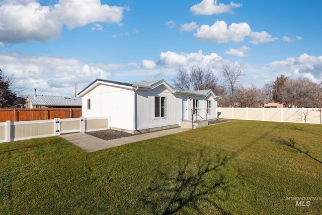 rear view of house with a lawn