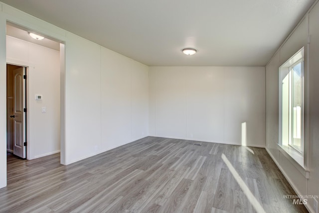 empty room with light hardwood / wood-style floors