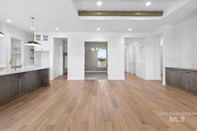 2716 N Heirloom Ave, Eagle, ID 83616 - unfurnished living room featuring recessed lighting, light wood finished floors, baseboards, and a raised ceiling