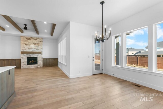 2716 N Heirloom Ave, Eagle, ID 83616 - unfurnished dining area featuring light wood-style floors, beamed ceiling, visible vents, a chandelier, and wainscoting