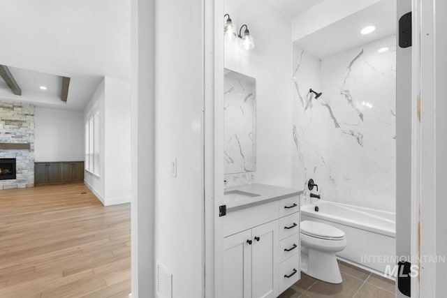 2716 N Heirloom Ave, Eagle, ID 83616 - full bath featuring a fireplace, vanity, shower / tub combination, toilet, and wood finished floors