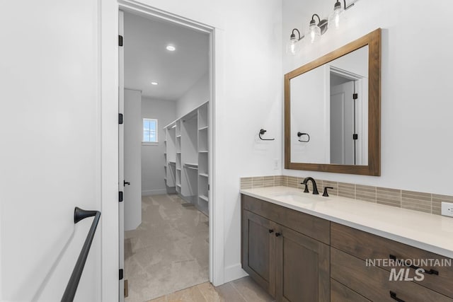 2716 N Heirloom Ave, Eagle, ID 83616 - bathroom featuring tasteful backsplash, vanity, and baseboards