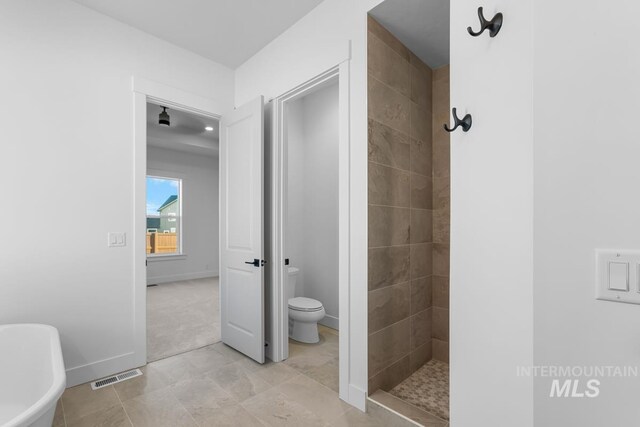 2716 N Heirloom Ave, Eagle, ID 83616 - full bath featuring baseboards, toilet, tiled shower, visible vents, and a freestanding bath