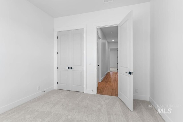 2716 N Heirloom Ave, Eagle, ID 83616 - unfurnished bedroom with a closet, visible vents, baseboards, and carpet