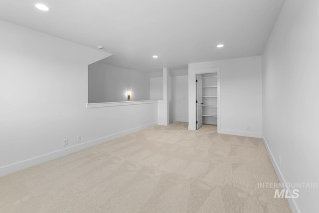 2716 N Heirloom Ave, Eagle, ID 83616 - unfurnished bedroom featuring a walk in closet, baseboards, recessed lighting, and light carpet