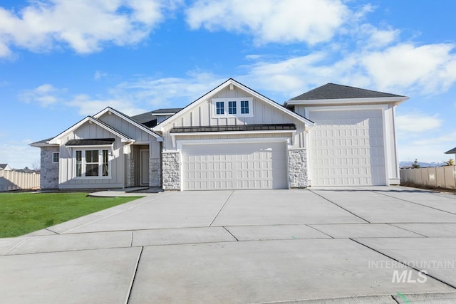2716 N Heirloom Ave, Eagle, ID 83616 - view of front of property with concrete driveway, board and batten siding, a front lawn, an attached garage, and fence