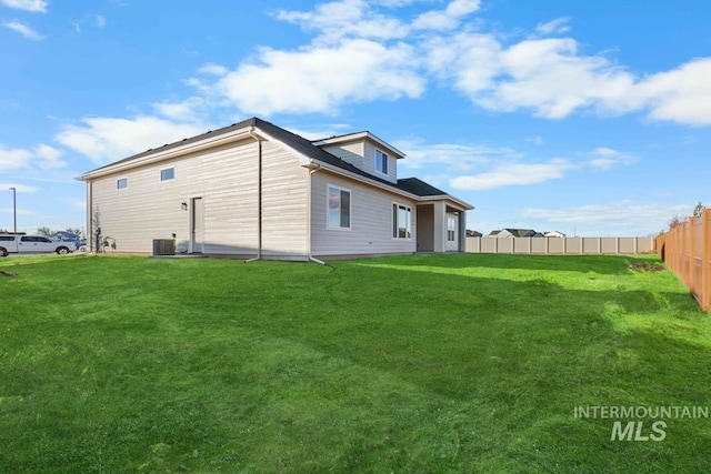 2716 N Heirloom Ave, Eagle, ID 83616 - rear view of house with fence, cooling unit, and a lawn