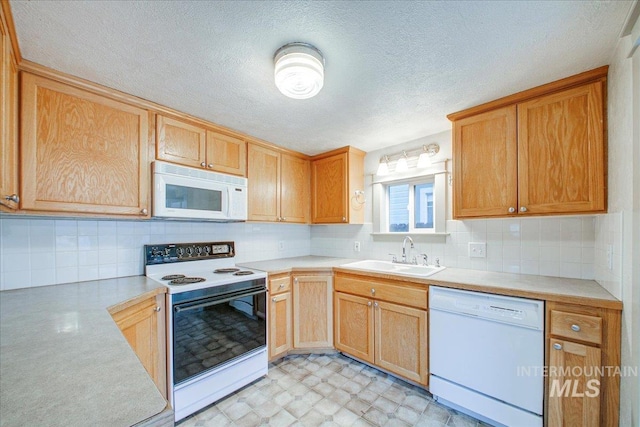 kitchen with white appliances, tasteful backsplash, and sink