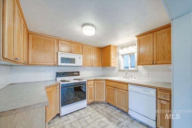 kitchen featuring backsplash, sink, a textured ceiling, and white appliances