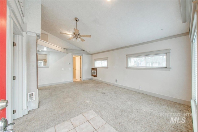 unfurnished room featuring light carpet, a textured ceiling, ceiling fan, and lofted ceiling