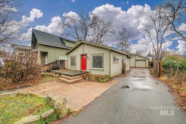 view of front of property featuring a garage and an outdoor structure