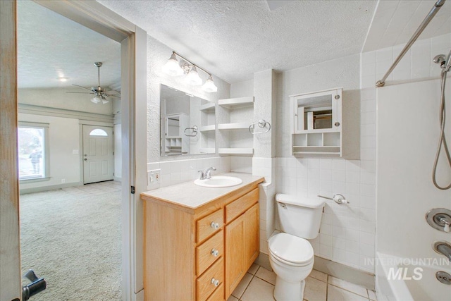 full bathroom featuring ceiling fan, shower / bath combination, vaulted ceiling, toilet, and vanity