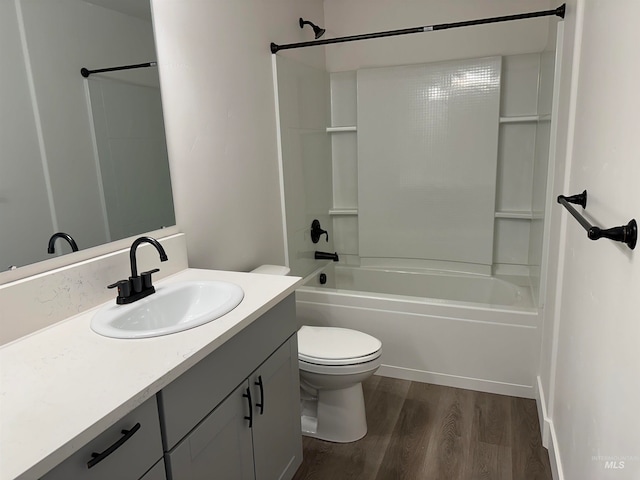 bathroom with toilet, shower / bath combination, wood finished floors, and vanity