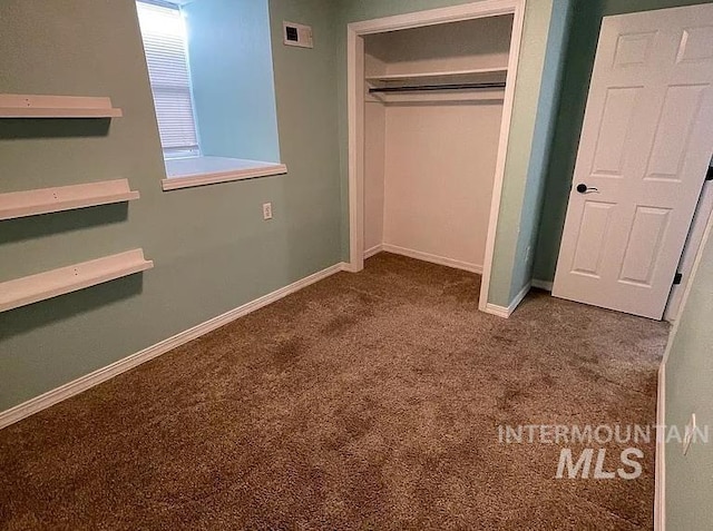 unfurnished bedroom with carpet floors and a closet